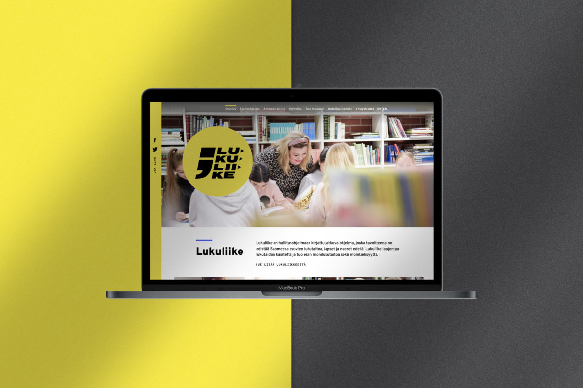 Lukuliike-verkkosivun näkymä MacBook Pro ruudulla keltamustalla taustalla.